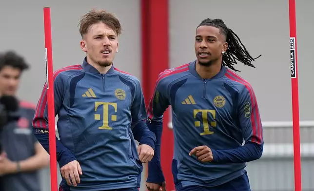 Munich's Lebbart Karl, left, and Michael Olise attend a training session in Munich, Germany, Tuesday, May 5, 2026, ahead of the Champions League semifinal second leg soccer match between FC Bayern and PSG. (AP Photo/Matthias Schrader)