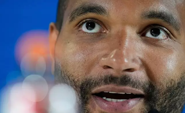 Munich's Jonathan Tan attends a press conference in Munich, Germany, Tuesday, May 5, 2026, ahead of the Champions League semifinal second leg soccer match between FC Bayern and PSG. (AP Photo/Matthias Schrader)