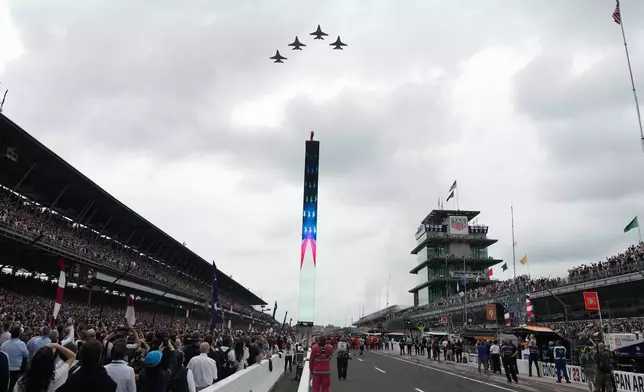 Fighter jets fly over the Indianapolis Motor Speedway during ceremonies before the start of the Indianapolis 500 auto race, Sunday, May 24, 2026 in Indianapolis. (AP Photo/AJ Mast)