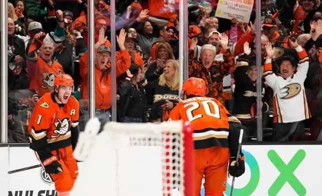 Anaheim Ducks center Leo Carlsson, left, celebrates his empty net goal with left wing Chris Kreider during the third period of Game 6 in the first round of the NHL hockey Stanley Cup playoffs series against the Edmonton Oilers, Thursday, April 30, 2026, in Anaheim, Calif. (AP Photo/Mark J. Terrill)