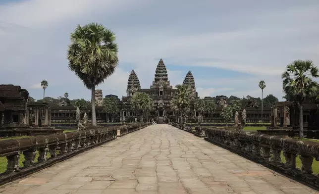 The mostly empty entrance way to the main section of the ancient Angkor Wat temple in Siem Reap, Cambodia on Sept. 16, 2022. (AP Photo/Anton L. Delgado)