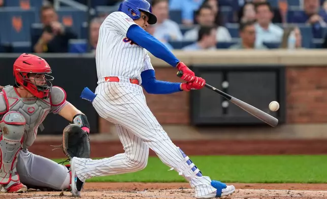 New York Mets' Juan Soto hits a home run during the first inning of a baseball game against the Cincinnati Reds, Wednesday, May 27, 2026, in New York. (AP Photo/Yuki Iwamura)