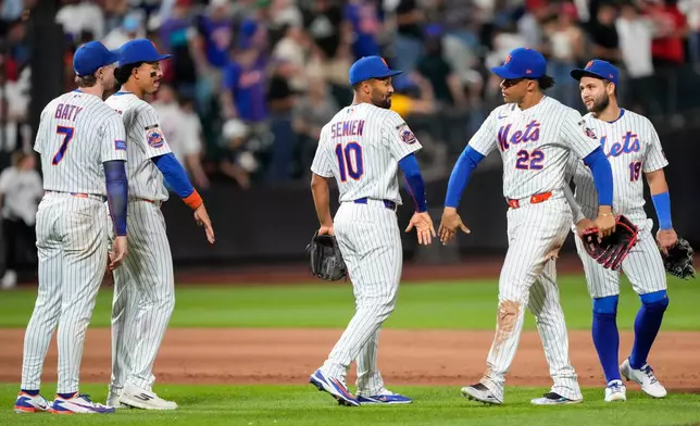 New York Mets left fielder Juan Soto (22) celebrates with second baseman Marcus Semien (10) after winning a baseball game against the Cincinnati Reds, Wednesday, May 27, 2026, in New York. (AP Photo/Yuki Iwamura)