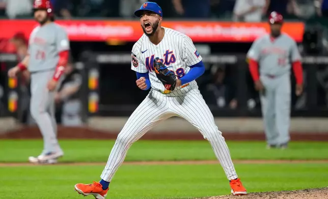 New York Mets pitcher Devin Williams (38) reacts after winning a baseball game against the Cincinnati Reds, Wednesday, May 27, 2026, in New York. (AP Photo/Yuki Iwamura)