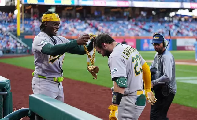 Athletics' Shea Langeliers (23) celebrates his two-run home run off of Philadelphia Phillies pitcher Andrew Painter with teammate Lawrence Butler during the first inning of a baseball game, Thursday, May 7, 2026, in Philadelphia. (AP Photo/Matt Rourke)