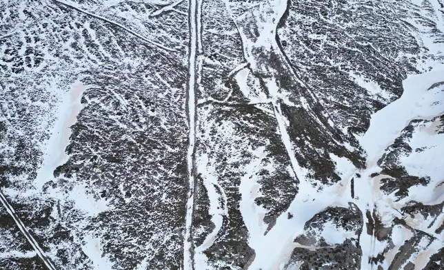 An aerial view shows melting snow on the slopes of Mount Parnassos at the Kelaria ski center in central Greece, on May 5, 2026. (AP Photo/Thanassis Stavrakis)