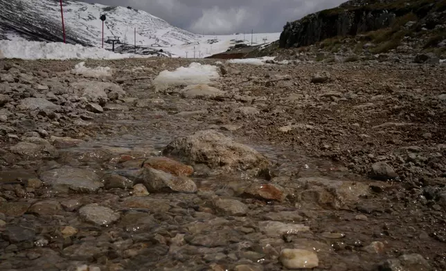 Water from melting snow flows down the slopes of Mount Parnassos at the Kelaria ski center in central Greece, on May 5, 2026. (AP Photo/Thanassis Stavrakis)