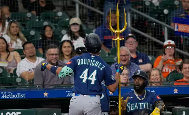 Seattle Mariners' Julio Rodríguez (44) celebrates after hitting a home run against the Houston Astros during the third inning of a baseball game Monday, May 11, 2026, in Houston. (AP Photo/David J. Phillip)