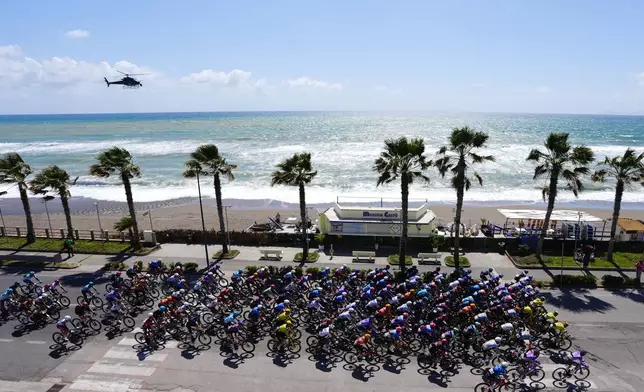 Riders pedals along the coastline during the 6th stage of the Giro d'Italia cycling race, from Paestum to Naples, Italy, Thursday, May 14, 2026. (Fabio Ferrari/LaPresse via AP)