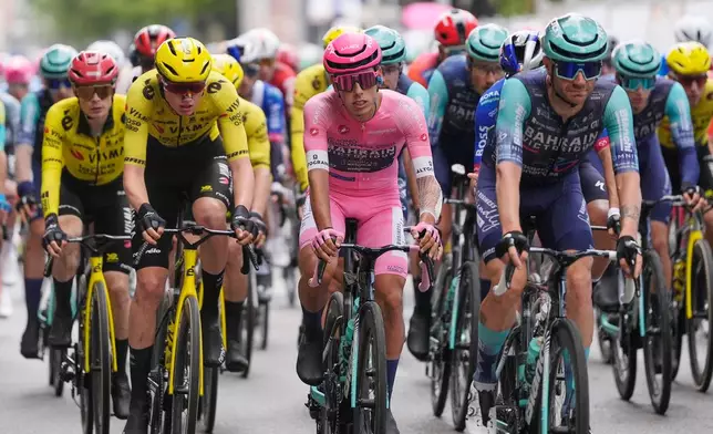 Portugal's Afonso Oliveira Eulalio wears the pink jersey of the race overall leader as he pedals in the pack, during the 6th stage of the Giro d'Italia cycling race, from Paestum to Naples, Italy, Thursday, May 14, 2026. (Fabio Ferrari/LaPresse via AP)