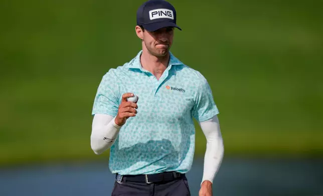 Alex Smalley waves on the 10th green during the third round of the PGA Championship golf tournament at Aronimink Golf Club, Saturday, May 16, 2026, in Newtown Square, PA. (AP Photo/Matt Slocum)