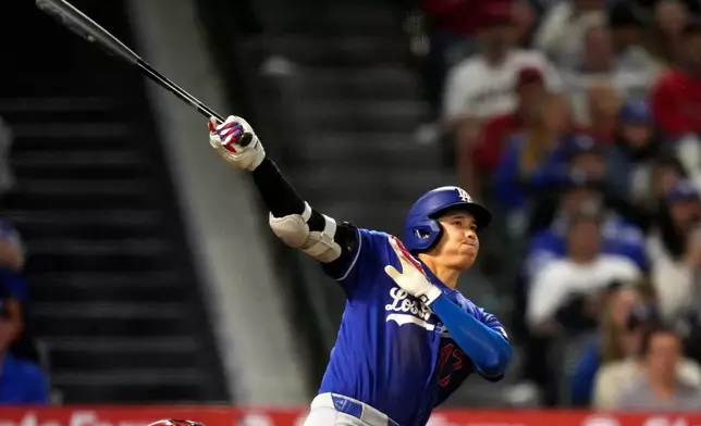 Los Angeles Dodgers' Shohei Ohtani hits a two-run triple during the eighth inning of a baseball game against the Los Angeles Angels, Saturday, May 16, 2026, in Anaheim, Calif. (AP Photo/Mark J. Terrill) CORRECTION: After official review, changed from three-run inside-the-park home run to two-run triple after a throwing error