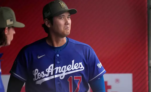 Los Angeles Dodgers' Shohei Ohtani stands in the dugout prior to a baseball game against the Los Angeles Angels, Saturday, May 16, 2026, in Anaheim, Calif. (AP Photo/Mark J. Terrill)