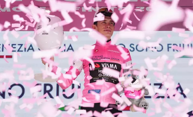 Denmark's Jonas Vingegaard wears the pink jersey of the race overall leader following stage 17 of the Giro d'Italia cycling race from Cassano D'Adda to Andalo, Italy, Wednesday, May 27, 2026. (Gianmattia D'Albertoi/LaPresse via AP) CORRECTION: race title corrected to overall leader only instead of him winning 17th stage