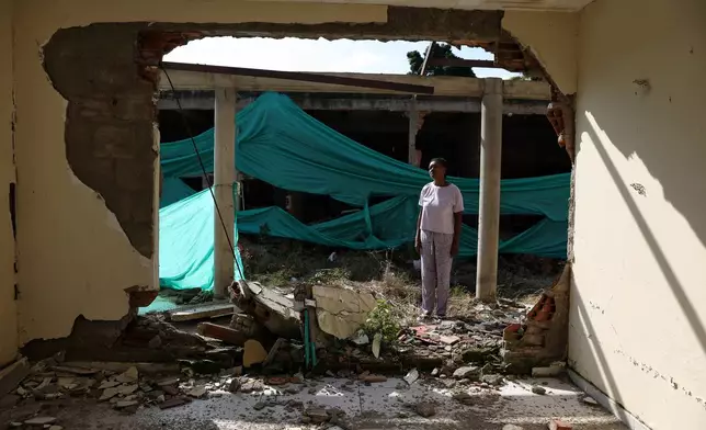 Eucaris Zamora stands in front of her home destroyed during an attack involving drones by a dissident branch of the former Revolutionary Armed Forces of Colombia, or FARC, guerrilla group in Robles, Colombia, Tuesday, May 19, 2026.(AP Photo/Santiago Saldarriaga)