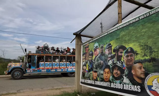A sign set up by dissidents of the former Revolutionary Armed Forces of Colombia, or FARC, displaying guerrilla leaders stands by a road to Buenos Aires, Cauca, Colombia, Wednesday, May 20, 2026. (AP Photo/Santiago Saldarriaga)