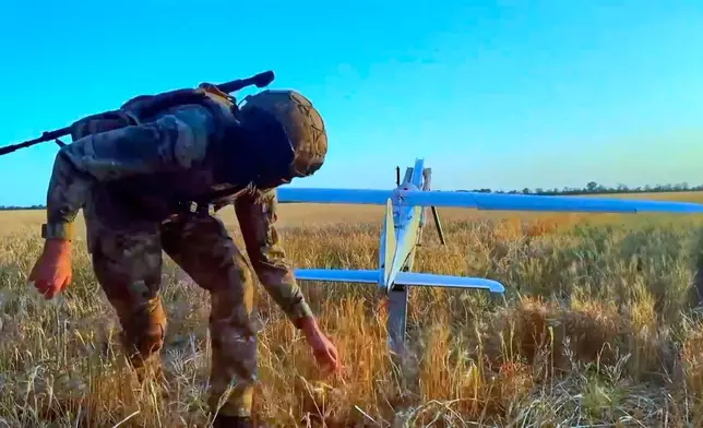 In this image made from video provided by Russian Defense Ministry Press Service on Wednesday, May 27, 2026, a Russian serviceman launches a drone for an action in an undisclosed location in Ukraine. (Russian Defense Ministry Press Service via AP)