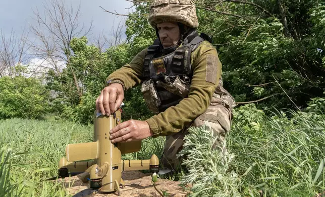 A Ukrainian soldier prepares an interceptor drone during a Russia's aerial attack at an undisclosed location near Kharkiv, Ukraine, Monday, May 25, 2026. (AP Photo/Andrii Marienko)