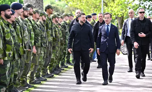 Sweden's Prime Minister Ulf Kristersson receives Ukraine's President Volodymyr Zelenskyy, center, at the F16 air flotilla in Uppsala, Sweden, Thursday, May 28, 2026. (Christine Olsson/TT News Agency via AP)