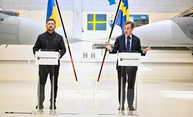 Sweden's Prime Minister Ulf Kristersson, right, and Ukraine's President Volodymyr Zelenskyy give a joint news conference at the F16 air flotilla in Uppsala, Sweden, Thursday, May 28, 2026. (Christine Olsson/TT News Agency via AP)