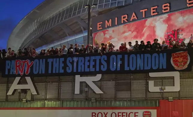 Arsenal supporters gather at the Arsenal stadium after Arsenal's soccer team won the Premier League title in London, Tuesday, May 19, 2026.(AP Photo/Alberto Pezzali)