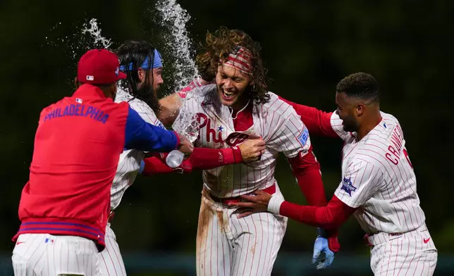 Philadelphia Phillies' Alec Bohm, secind from right, celebrates with teammates after his walkoff sacrifice fly during the 10th inning of the second baseball game of a doubleheader against the San Francisco Giants, Thursday, April 30, 2026, in Philadelphia. (AP Photo/Derik Hamilton)
