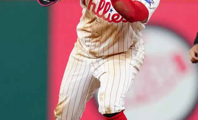 Philadelphia Phillies' Kyle Schwarber reacts after hitting a RBI double off San Francisco Giants pitcher Keaton Winn during the ninth inning of the second baseball game of a doubleheader, Thursday, April 30, 2026, in Philadelphia. (AP Photo/Derik Hamilton)
