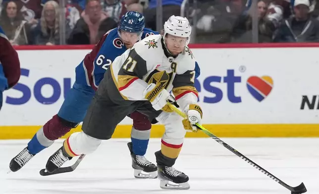 Vegas Golden Knights center William Karlsson, front, collects the puck as Colorado Avalanche left wing Artturi Lehkonen (62) pursues during the second period in Game 2 of the Western Conference finals NHL hockey Stanley Cup playoff series Friday, May 22, 2026, in Denver. (AP Photo/David Zalubowski)