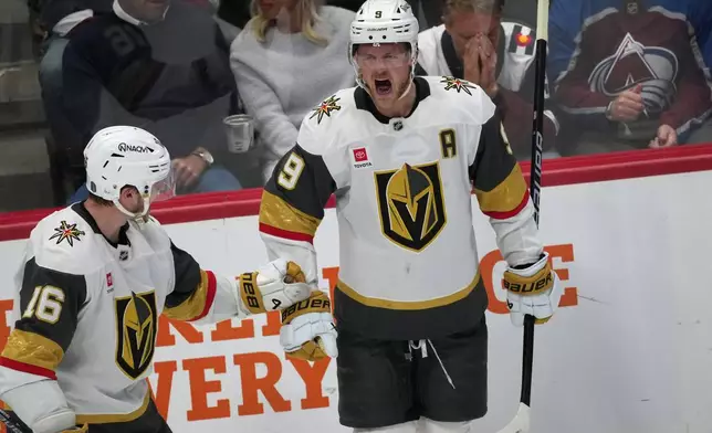 Vegas Golden Knights center Jack Eichel, right, is congratulated after scoring by right wing Pavel Dorofeyev, left, during the third period in Game 2 of the Western Conference finals NHL hockey Stanley Cup playoff series against the Colorado Avalanche, Friday, May 22, 2026, in Denver. (AP Photo/David Zalubowski)