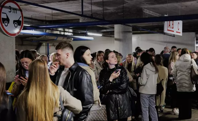 People take shelter in an underground car park during an air raid alert in Vilnius, Lithuania, Wednesday, May 20, 2026. (Vygintas Skaraitis/Lrytas via AP)