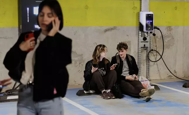 People take shelter in an underground car park during an air raid alert in Vilnius, Lithuania, Wednesday, May 20, 2026. (Vygintas Skaraitis/Lrytas via AP)