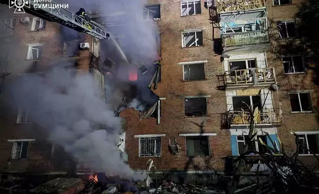 In this photo provided by the Ukrainian Emergency Services on Wednesday, May 20, 2026, rescue workers put out a fire of a residential building damaged after a Russian strike on Konotop, Ukraine. (Ukrainian Emergency Service via AP)