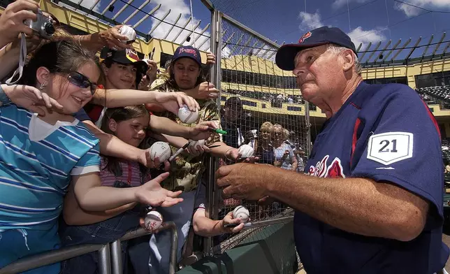 FILE - Atlanta Braves manager Bobby Cox signs autographs for fans prior to the start of the spring training game with the New York Mets on March 27, 2003 at Disney's Wide World of Sports Complex in Lake Buena Vista, Fla. (AP Photo/Tony Ranze, File)