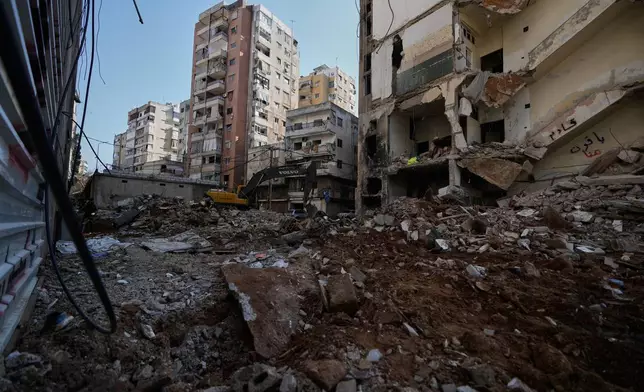A bulldozer clears the rubble where a sports clothing shop was destroyed in a previous Israeli airstrike in Chiyah, a southern Beirut suburb, May 6, 2026. (AP Photo/Bilal Hussein)