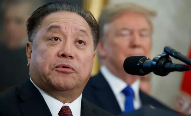 FILE - In this Nov. 2, 2017, file photo, Broadcom CEO Hock Tan speaks as President Donald Trump listens during an event to announce the company is moving its global headquarters to the United States, in the Oval Office of the White House, in Washington. (AP Photo/Evan Vucci, File)