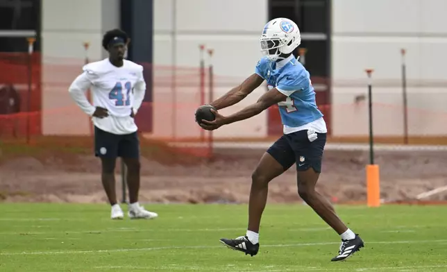 Tennessee Titans wide receiver Carnell Tate makes a catch during NFL football practice, Thursday, May 21, 2026, in Nashville, Tenn. (AP Photo/John Amis)