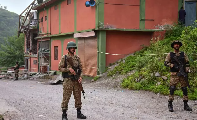 FILE - Army soldiers stand guard at a mosque building damaged by a suspected Indian missile attack near Muzaffarabad, the capital of Pakistan controlled Kashmir, on Wednesday, May 7, 2025. (AP Photo/M.D. Mughal, File)