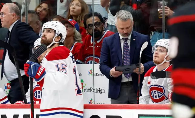 Montreal Canadiens head coach Martin St Louis, center right, looks to challenge a goal by the Carolina Hurricanes during the first period in Game 5 of the Eastern Conference finals NHL hockey Stanley Cup playoff series in Raleigh, N.C., Friday, May 29, 2026. (AP Photo/Karl DeBlaker)