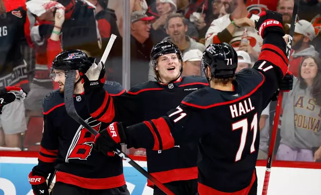 Carolina Hurricanes' Jackson Blake (53) celebrates his goal with teammate Taylor Hall (71) during the second period in Game 5 of the Eastern Conference finals NHL hockey Stanley Cup playoff series against the Montreal Canadiens in Raleigh, N.C., Friday, May 29, 2026. (AP Photo/Karl DeBlaker)