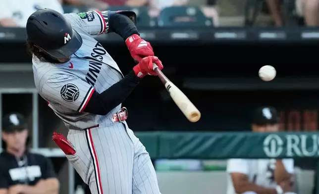 Minnesota Twins' Austin Martin hits a one-run single during the fourth inning of a baseball game against the Chicago White Sox in Chicago, Tuesday, May 26, 2026. (AP Photo/Nam Y. Huh)