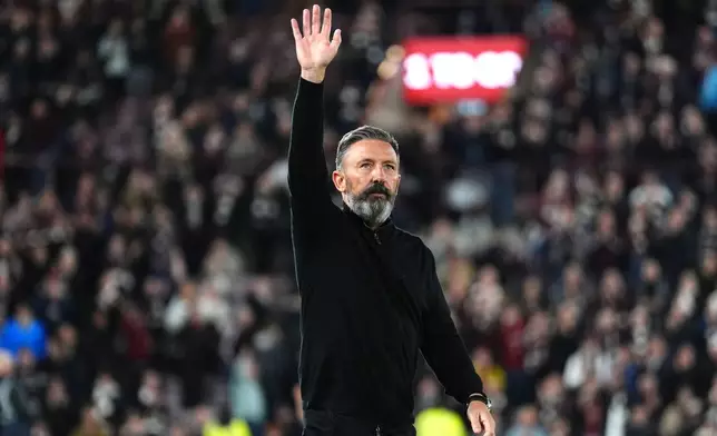 Heart of Midlothian manager Derek McInnes acknowledges the fans following the Scottish Premiership soccer match between Heart of Midlothian and Falkirk, Wednesday, May 13, 2026, in Edinburgh, Scotland. (Andrew Milligan/PA via AP)