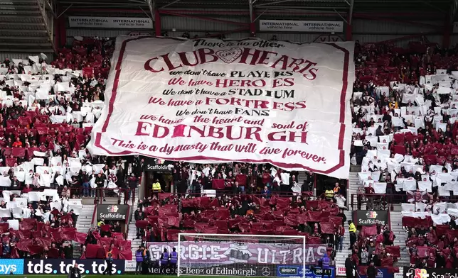 Heart of Midlothian unfurl a large banner ahead the Scottish Premiership soccer match between Heart of Midlothian and Falkirk, Wednesday, May 13, 2026, in Edinburgh, Scotland. (Andrew Milligan/PA via AP)