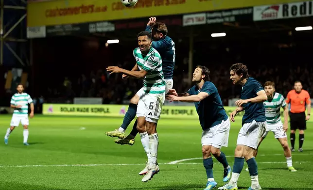 Motherwell's Sam Nicholson fouls Celtic's Auston Trusty, left, in the box resulting in a penalty being awarded to Celtic during the Scottish Premiership soccer match between Motherwell and Celtic, Wednesday, May 13, 2026, in Motherwell, Scotland. (Robert Perry/PA via AP)