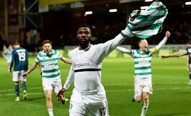 Celtic's Kelechi Iheanacho celebrates scoring their side's third goal from a penalty during the Scottish Premiership soccer match between Motherwell and Celtic, Wednesday, May 13, 2026, in Motherwell, Scotland. (Robert Perry/PA via AP)