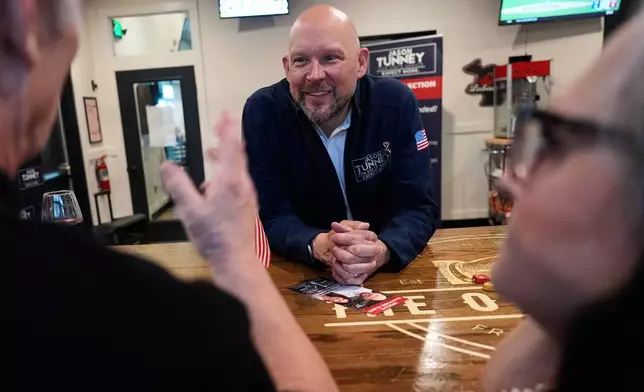 Jason Tunney, Republican candidate for the 35th Senate District, speaks with supporters at Otherside Bar and Grill Monday, April 27, 2026, in Freeland, Mich. (AP Photo/Paul Sancya)