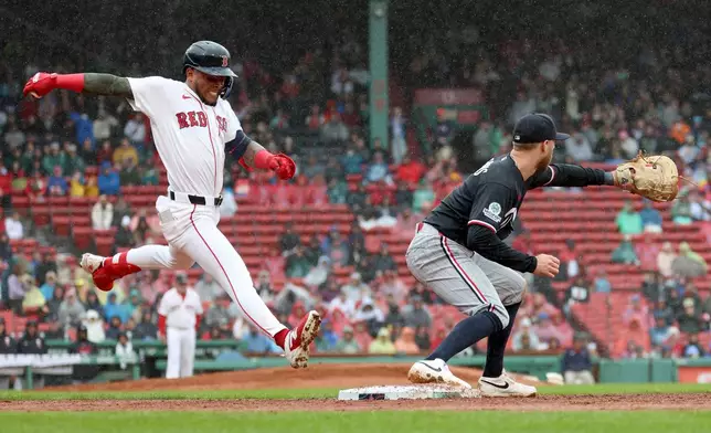 Minnesota Twins first baseman Kody Clemens, right, makes an out against Boston Red Sox's Ceddanne Rafaela, left, during the third inning of a baseball game, Sunday, May 24, 2026, in Boston. (AP Photo/Mark Stockwell)