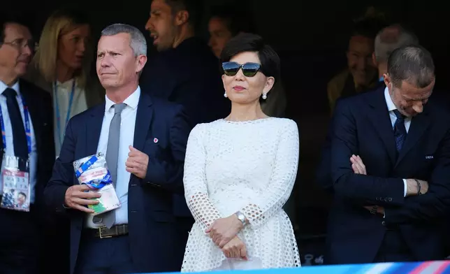Michele Kang, owner of OL Lyonnes, stands on the tribune next to UEFA President Aleksander Ceferin, right, during the Women's Champions League final soccer match between FC Barcelona and OL Lyonnes, in Oslo, Saturday, May 23, 2026. (AP Photo/Kirsty Wigglesworth)