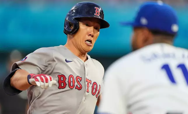Boston Red Sox's Masataka Yoshida runs to third after hitting a triple during the fourth inning of a baseball game, Monday, May 18, 2026, in Kansas City, Mo. (AP Photo/Charlie Riedel)