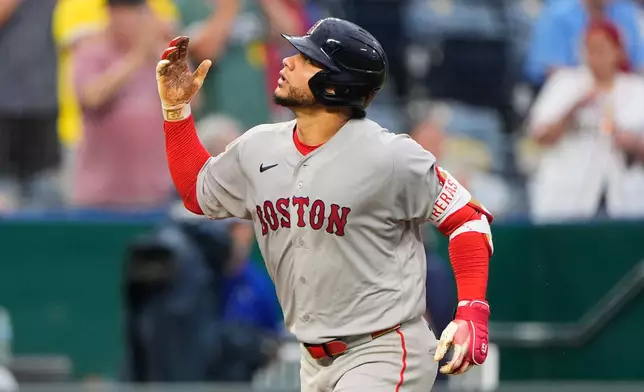 Boston Red Sox's Willson Contreras celebrates as he runs home after hitting a two-run home run during the sixth inning of a baseball game against the Kansas City Royals, Monday, May 18, 2026, in Kansas City, Mo. (AP Photo/Charlie Riedel)
