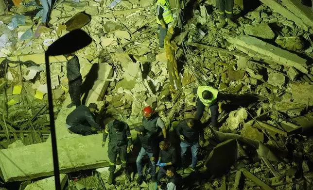 Rescue workers search through the rubble of a damaged building for survivors following an Israeli airstrike in Dahiyeh, Beirut's southern suburbs, Lebanon, Wednesday, May 6, 2026. (AP Photo/Hassan Ammar)